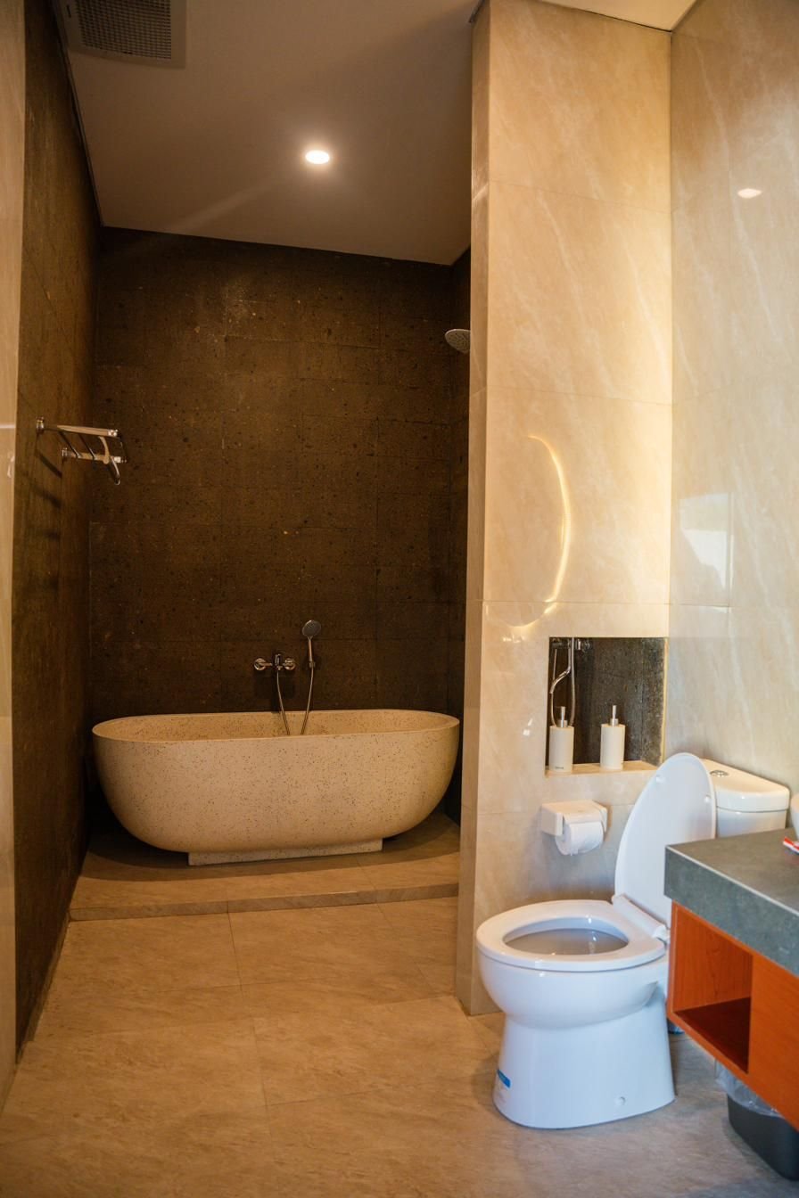 Stone bathtub and rain shower