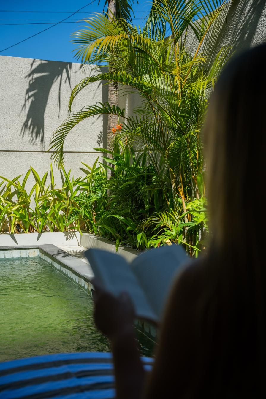 Reading a book beside the private pool